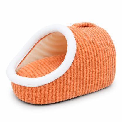 Warm-orange slipper-shape plush pet cave bed with white plush trim and carry handle