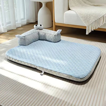 Sky Blue cooling pet mat with monster bolster pillow set up beside a sofa