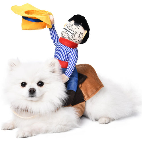 White Pomeranian lying down wearing the cowboy rider dog costume, saddle across the back and the plush rider holding his hat in the air